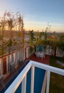 a view of a swimming pool on a balcony with a table at villa la perle in Asilah