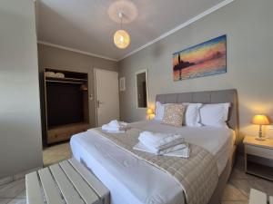 a bedroom with a large bed and a television at Sigma Hotel in Paralia Vrachou +66 photos