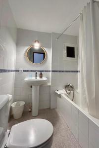 a white bathroom with a toilet and a sink at Ca sa Madona Hostal in Paguera