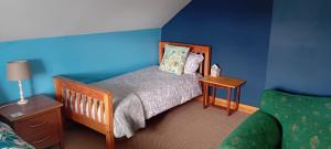 a small bedroom with a bed and a nightstand and a bed sidx sidx sidx at Lakeview in Fenagh