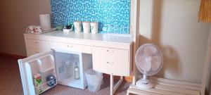 a toy kitchen with a counter with a refrigerator and a fan at Lakeview in Fenagh
