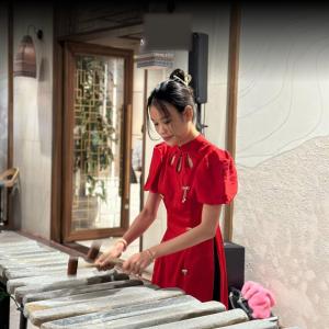 a woman in a red dress playing a keyboard at Maris Apec Tuy Hoà in Tuy Hoa +32 photos