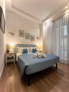 a bedroom with a bed with two towels on it at Tre R Colosseo in Rome
