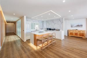 a kitchen with a island in the middle of a room at Apartment Vistamar II in Port de Pollensa