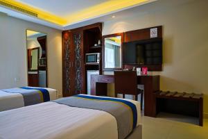 a hotel room with two beds and a desk at Al Muhaidb Al Olaya Suites - Economic in Riyadh +65 photos