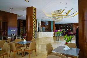 a restaurant with tables and chairs and a lobby at Al Muhaidb Al Olaya Suites - Economic in Riyadh