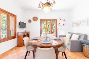 a living room with a wooden table and chairs at Casita Sa Calobra in Cala Tuent