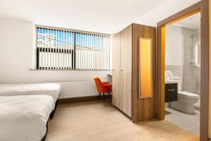 a hotel room with a bed and a bathroom at Clanbrassil Townhouse in Dundalk