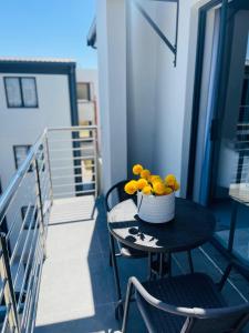 a bowl of flowers sitting on a table on a balcony at Cozy and Warm-Private Queen Bedroom with Private Bathroom & shared Kitchen& Lounge in Parklands