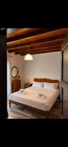 a bedroom with a large bed with white sheets at Azure Escape Villa in Platamonas +5 photos
