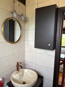 a bathroom with a sink and a mirror at Azure Escape Villa in Platamonas