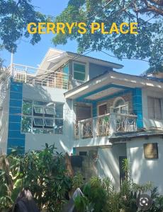 a large white house with a balcony on it at Gerry's Place in Iloilo City