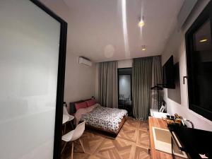 a living room with a bed and a television at A&D Studio in Klíma