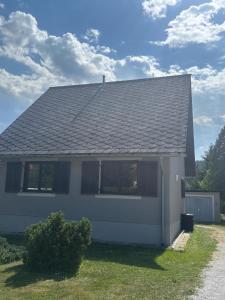 a white house with a gray roof at Ferienhaus Michi in Ursprung