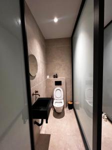a bathroom with a white toilet and a sink at A&D Studio in Klíma +15 photos
