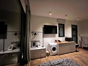 a living room with a washer and dryer at A&D Studio in Klíma