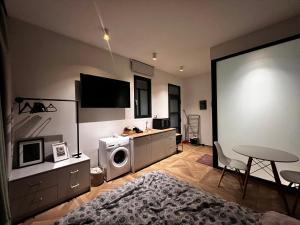 a living room with a tv and a table and a couch at A&D Studio in Klíma