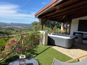 a garden with a bath tub on the grass at La Lézardière - Suites de Prestige & Spas Privatifs in Porto-Vecchio