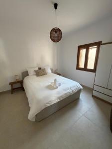 a bedroom with a bed with two candles on it at Patmian charm 2 bedrooms in Skala