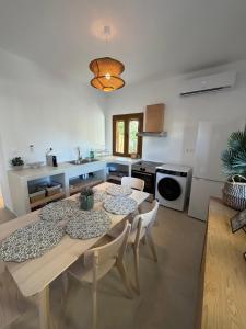 a kitchen and dining room with a table and chairs at Patmian charm 2 bedrooms in Skala +10 photos