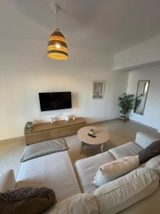 a living room with a couch and a table at Patmian charm 2 bedrooms in Skala