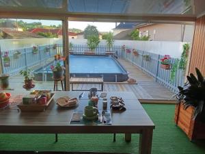 a patio with a table and a swimming pool at la passerelle in Maurs