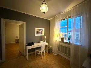 a room with a desk and a window with a chair at Våning Margareta in Kalmar