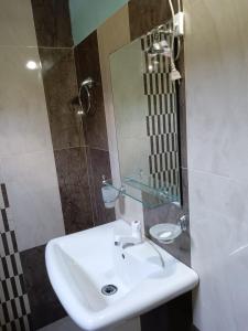a bathroom with a sink and a mirror at Green Gardens in Weligama