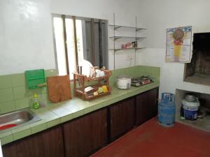 a kitchen with a sink and a counter top at Green Gardens in Weligama