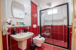a bathroom with a toilet and a sink and a shower at Royalis Apart Hotel in Fethiye +47 photos