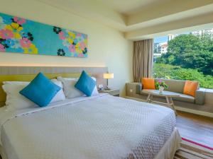 a bedroom with a large bed and a window at Mercure Penang Beach in George Town +60 photos