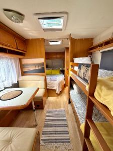 a small room with two bunk beds and a table at Highway to Hel in Jastarnia
