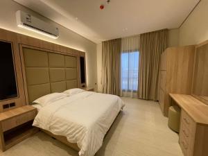 a bedroom with a large bed and a large window at شقة O&Me الفندقية in Medina