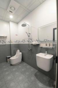 a bathroom with a sink and a shower and a toilet at Willow Stay in Hai Phong +16 photos