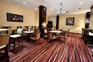 a dining room with tables and chairs on a rug at Central Albany Room with Breakfast & view in Albany
