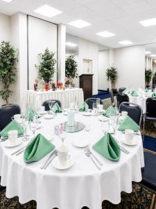 a conference room with white tables and green napkins at Central Albany Room with Breakfast & view in Albany