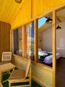 a bedroom with a bed and a large window at Falcon'S Cottages in Meruk