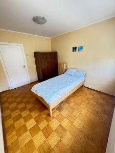 a bedroom with a bed and a wooden floor at Joy Haven in Tallinn +3 photos