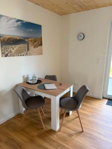 a table with two chairs and a laptop on it at Haus Bahnhofsblick in Ottersberg