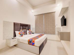 a bedroom with a large bed and a television at Hotel Paradise Palace in Ghaziabad