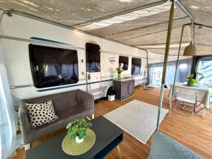 a living room with a couch and a table in a caravan at Highway to Hel in Jastarnia