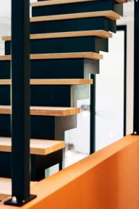 a staircase in a building with wooden steps at Villa de Luxe à Malmedy pour 14 personnes en Ardenne in Malmedy