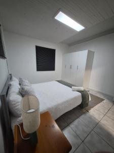 a bedroom with a bed and a television in it at 52 on 2nd Self-catering accommodation in Gonubie Park