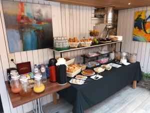a table with food and drinks on it at Race & Rooms in Francorchamps