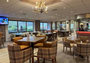 a restaurant with tables and chairs and a bar at The Chase Golf & Country Club in Penkridge