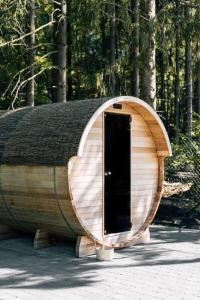 a round wooden building with a door in the middle at Villa de Luxe à Malmedy pour 14 personnes en Ardenne in Malmedy +24 photos