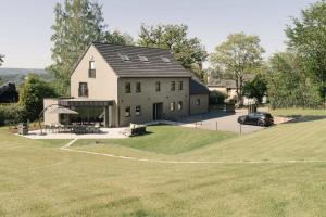 a large house with a car parked in front of it at Villa de Luxe à Malmedy pour 14 personnes en Ardenne in Malmedy