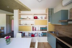 a kitchen with a white counter and some shelves at Casa Vacanze Al Cielo 2 in Sarnano