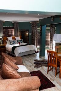 a large bedroom with a bed and a couch at Big 5 Guest House Witbank in eMalahleni +105 photos
