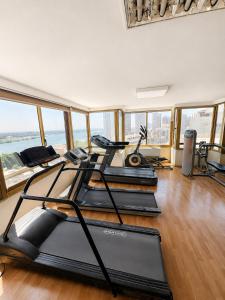 a gym with several treadmills and elliptical machines at Maadi Hotel in Cairo